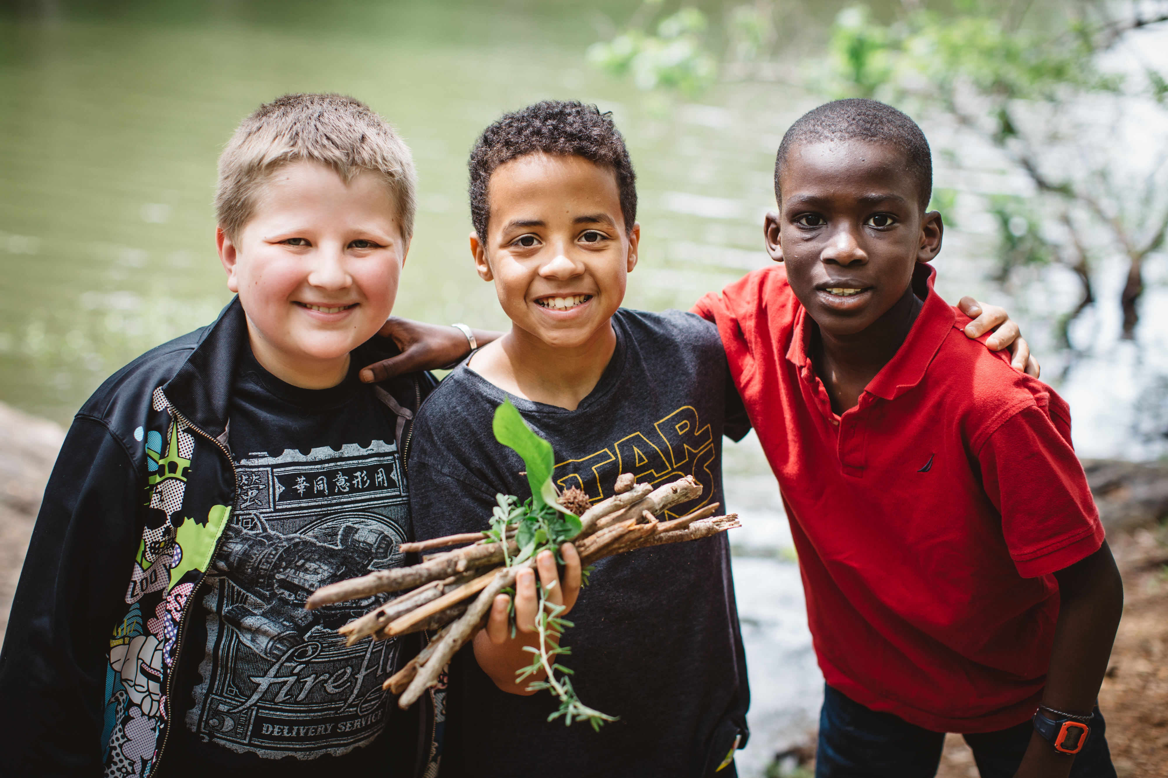 boys with sticks on a Muddy Sneakers program